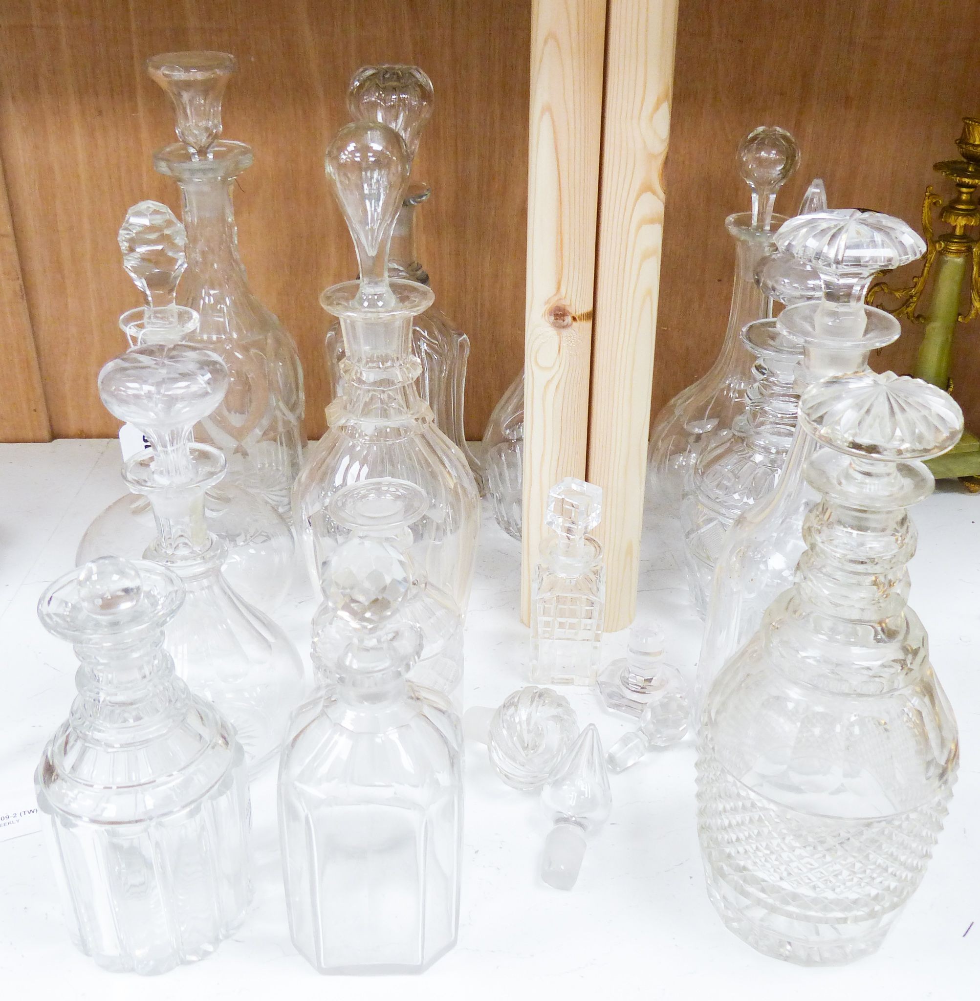 A collection of thirteen cut glass decanters